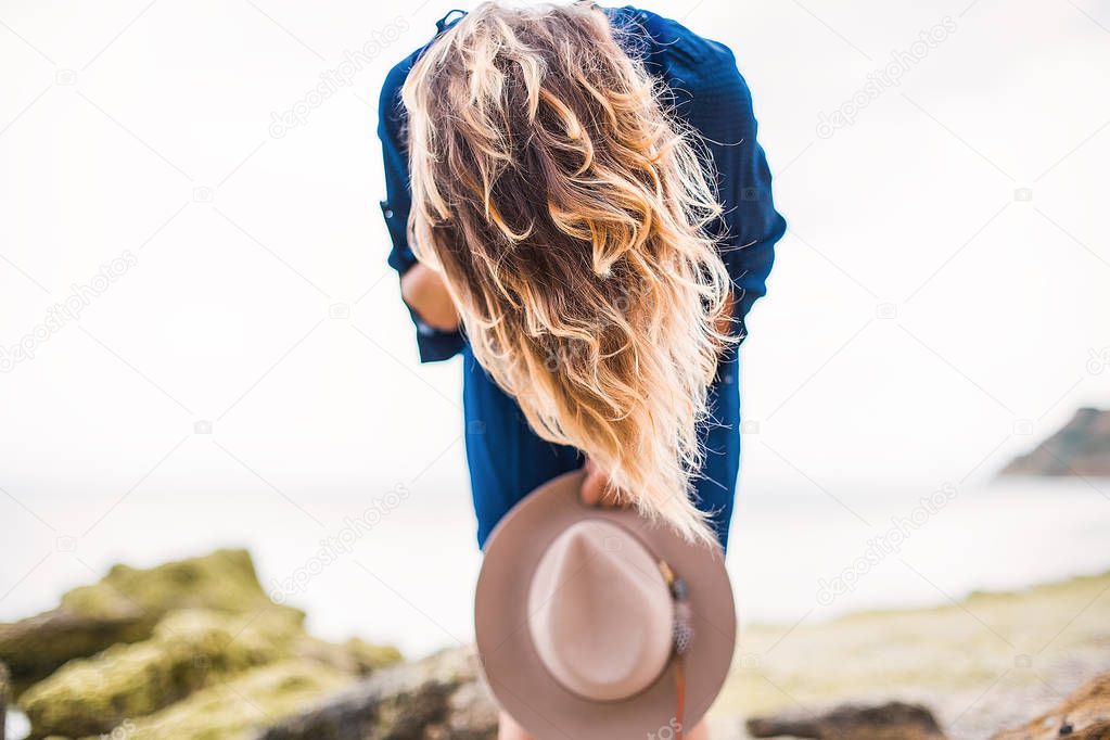young girl holding vintage hat