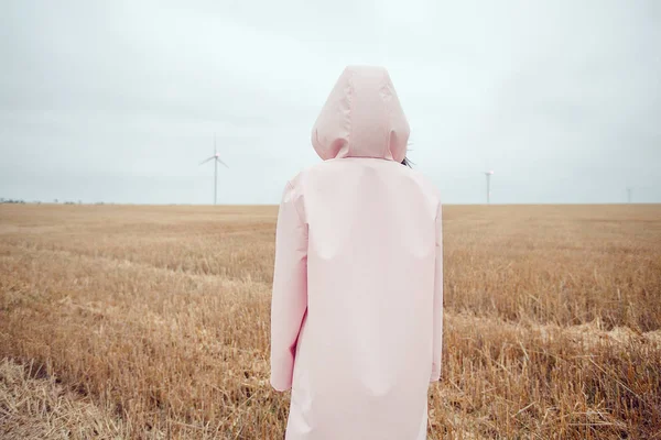 girl in pink raincoat with hood