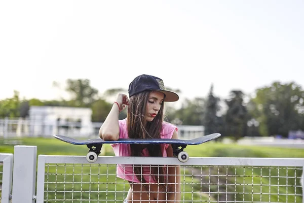 Young woman with skateboard — Stock Photo, Image