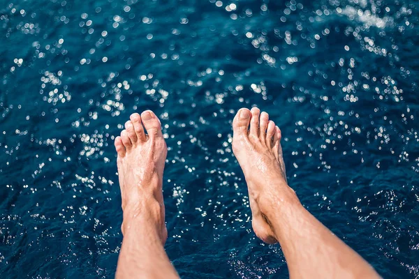 legs in the clear sea water.