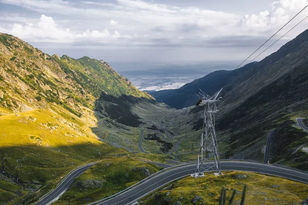 Beautiful serpentine road and electric pole in mountains