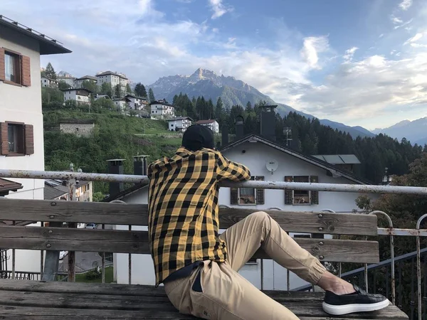 Mann Freizeitkleidung Ruht Auf Holzbank Auf Aussichtsplattform Dorf Mit Bergblick — Stockfoto
