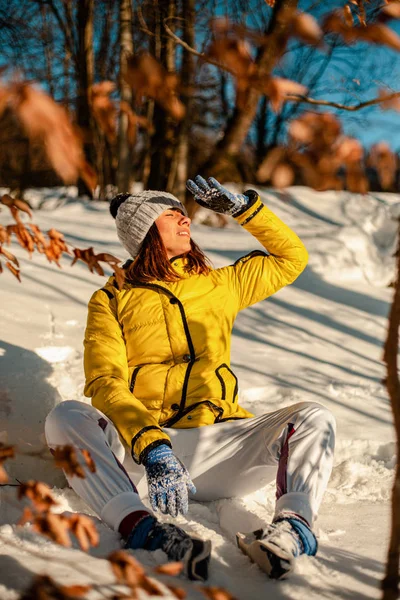 Beautiful Woman Warm Clothes Looking Aside While Sitting Snow Sunny — Stok fotoğraf