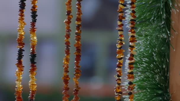 Amber necklace hanging in souvenir stand — Stockvideo