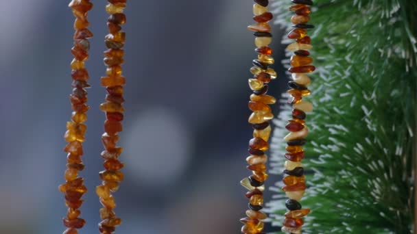 Amber necklace hanging in souvenir stand — Stockvideo