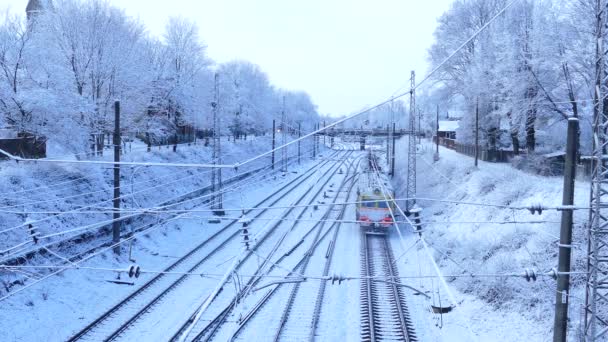 Suburban passenger train departing in snowy winter day — Stock Video