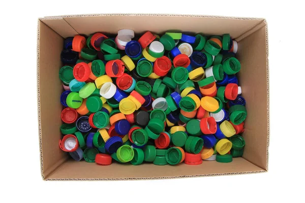 Plastic pet caps in paper box — Stock Photo, Image