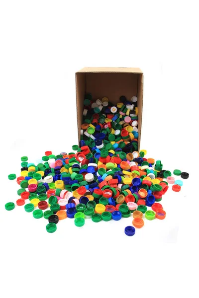 Plastic pet caps in paper box — Stock Photo, Image