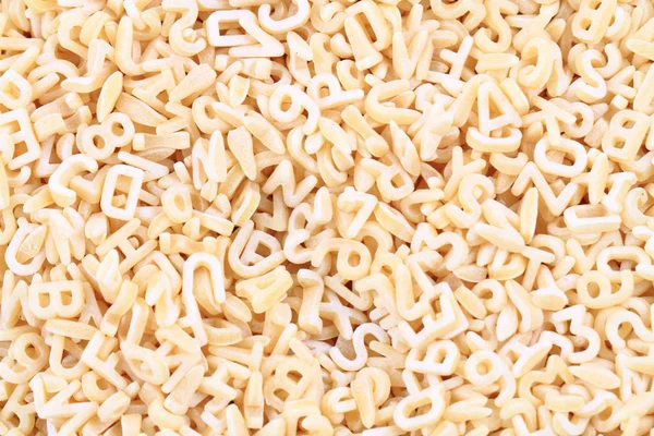 Alphabet pasta as nice background — Stock Photo, Image