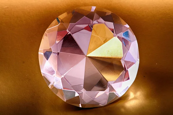 Diamnod on the golden background — Stock Photo, Image