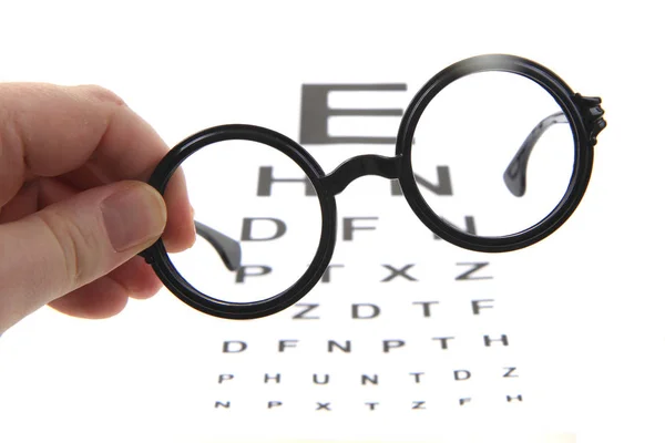 Óculos e teste óptico — Fotografia de Stock