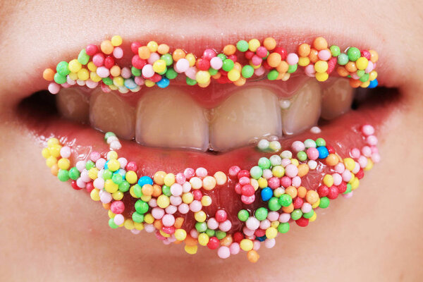 woman lips in color sugar spheres