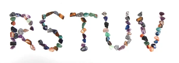 Alfabet z koloru kamienie mineralne — Zdjęcie stockowe