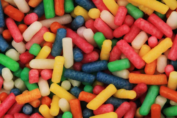 Цвет сахарной радуги украшения текстуры — стоковое фото