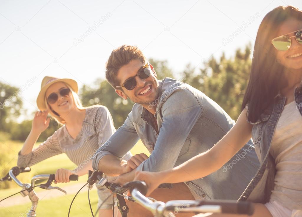 Friends cycling in park