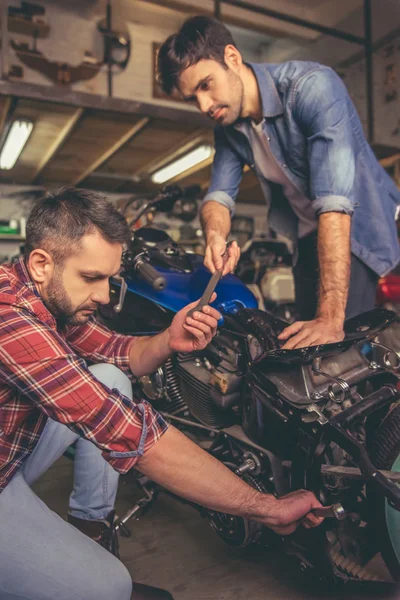 Guys at the motorbike repair shop