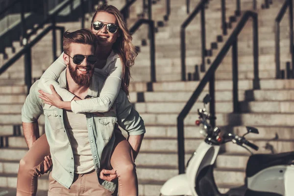 Couple with a scooter — Stock Photo, Image