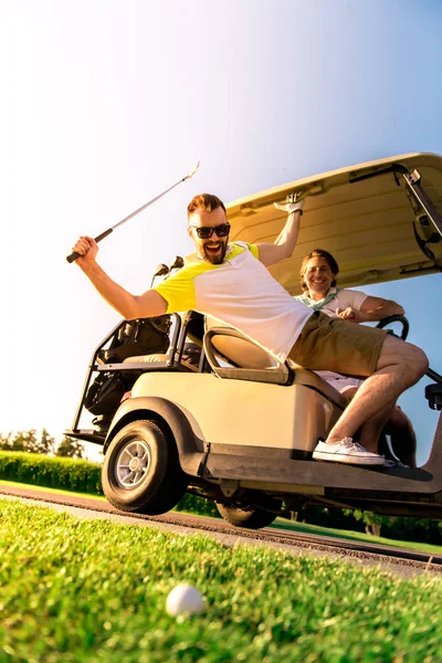 Men playing golf