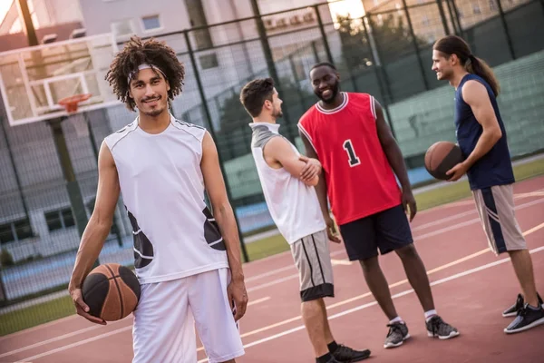 Guys playing basketball