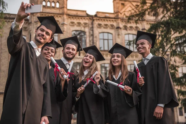 Happy young alumni — Stock Photo, Image