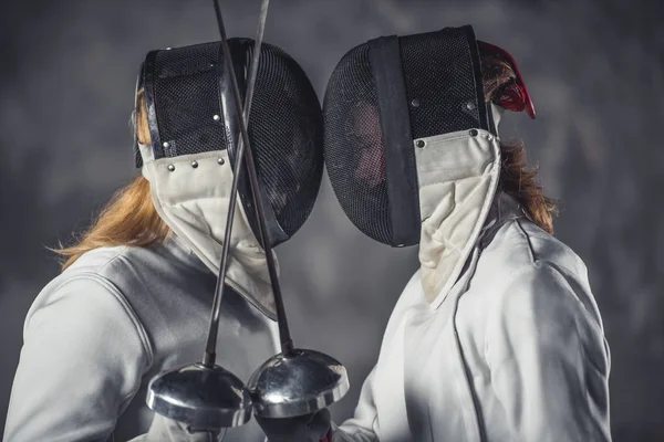 Two women fencing