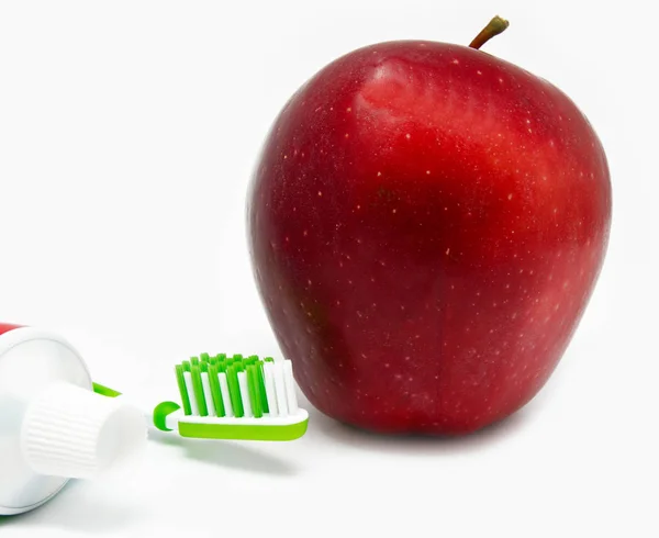 Apple, thothbrush, toothpaste on white — Stock Photo, Image