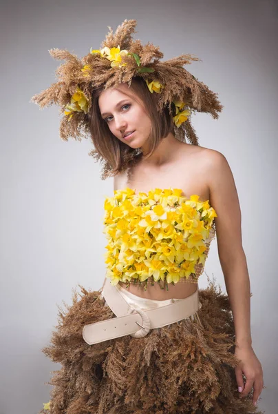 young woman in a wreath of reeds and daffodils