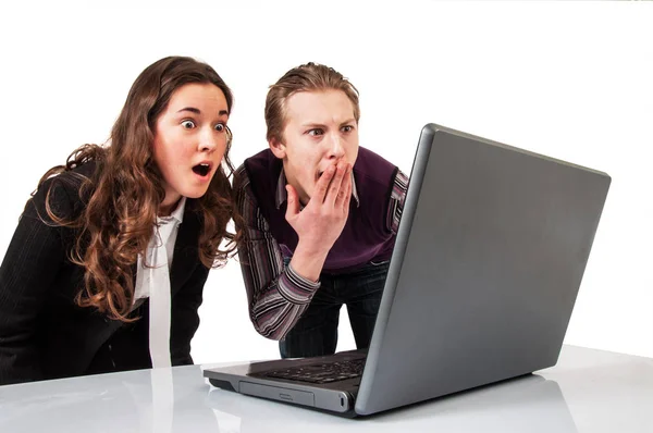 Förvånad över par på rad med en bärbar dator — Stockfoto