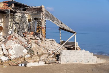Building destroyed after storm in the beach clipart