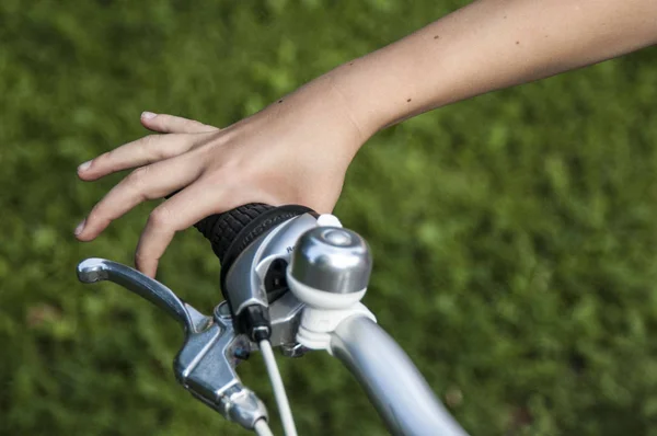 Bicycle wheel and child's hand. — Stock Photo, Image