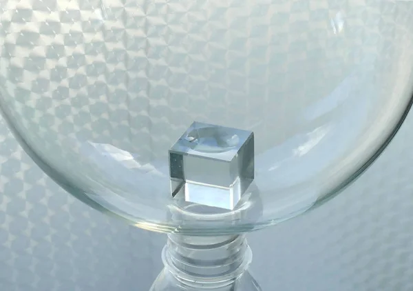 Abstract glassware. Glass cube in a glass sphere.