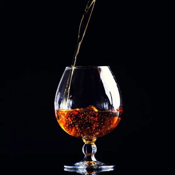 Glass Cognac Splash Black Background — Stock Photo, Image