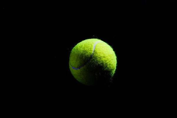 Tennis Ball isolated on black with dramatic lighting — Stock Photo, Image