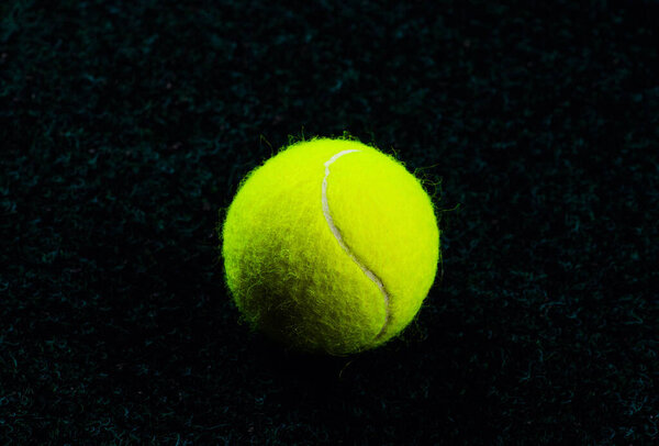 Tennis Ball isolated on black with dramatic lighting