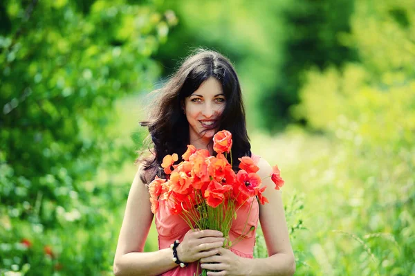 Happy woman with a bouquet of flowers — Stock Photo, Image