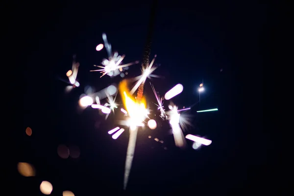 Sparks in the dark. Sparks. Christmas and New Year time. Magic l — Stock Photo, Image