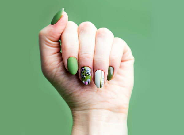 Nails Design. Hands With Bright Green and White Manicure On Gree