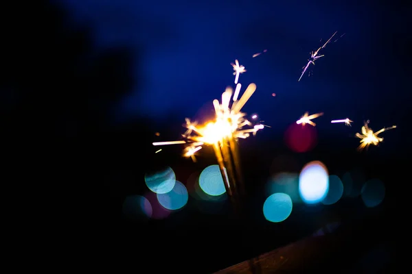 Sparks in the dark. Sparks. Christmas and New Year time. Magic l — Stock Photo, Image