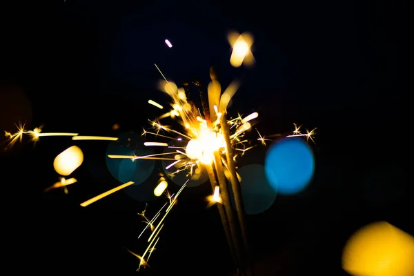 Sparks in the dark. Sparks. Christmas and New Year time. Magic l Stock Photo
