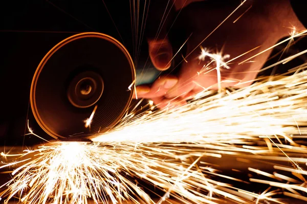 Metal grinding on steel pipe with flash of sparks close up — Stock Photo, Image