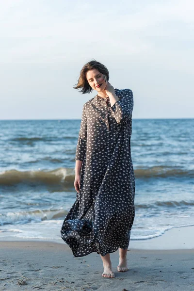 Belle fille dans une robe posant près de la mer — Photo