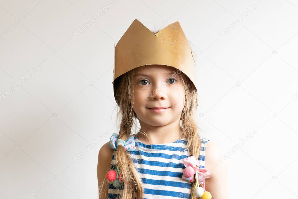 little girl posing in a golden crown