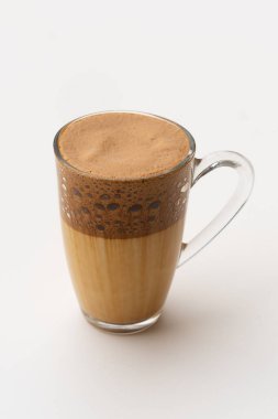 Kahverengi kahve standı olan şeffaf bir fincan.