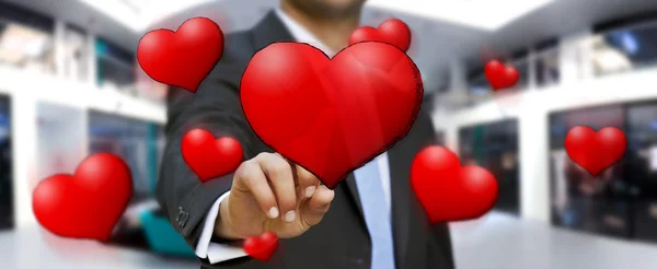 Young man touching hand drawn red heart — Stock Photo, Image