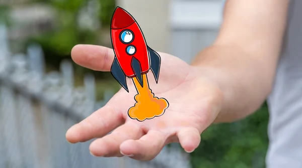 拿着红色的商人在他的手手绘制的火箭 — 图库照片