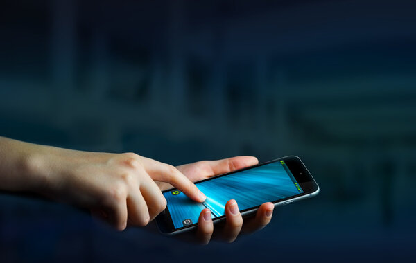 Businesswoman using modern mobile phone