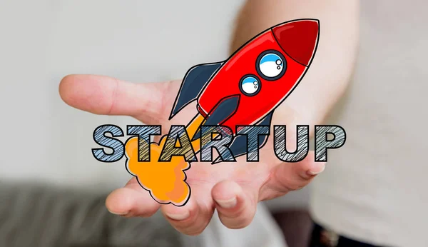 Affärsmannen hålla hand dras start text och röd raket — Stockfoto