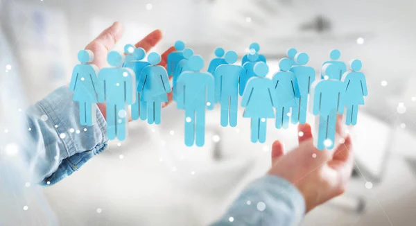Επιχειρηματίας κρατώντας 3d rendering ομάδα ανθρώπων στο χέρι — Φωτογραφία Αρχείου