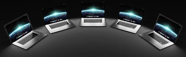 Пять современных ноутбуков в темном 3D рендеринге — стоковое фото