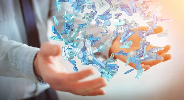 Бізнесмен тримає 3D рендерингову групу блакитних людей — стокове фото